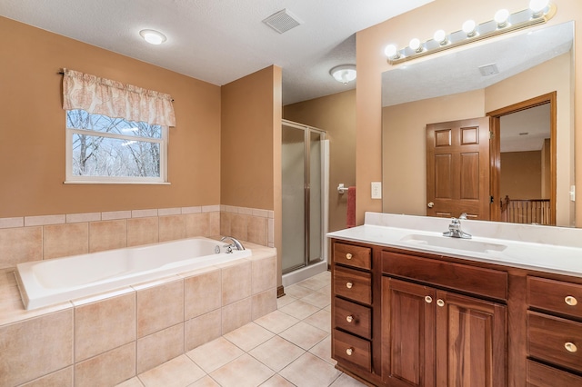 bathroom with tile patterned floors, a garden tub, visible vents, and a shower stall