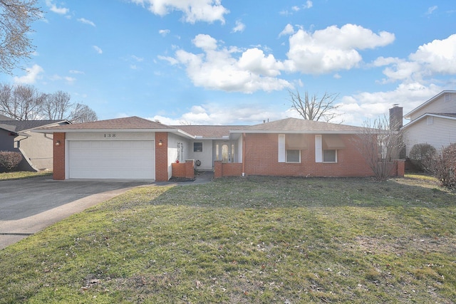 single story home with a front lawn, brick siding, an attached garage, and driveway