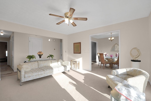 living room featuring light colored carpet and ceiling fan with notable chandelier