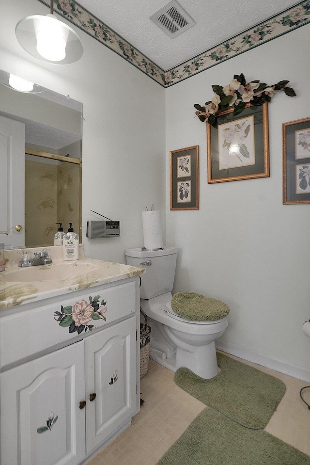 full bathroom with a shower with shower door, visible vents, toilet, a textured ceiling, and vanity