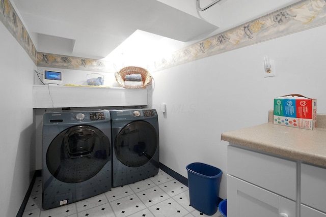 laundry area with baseboards, cabinet space, and separate washer and dryer