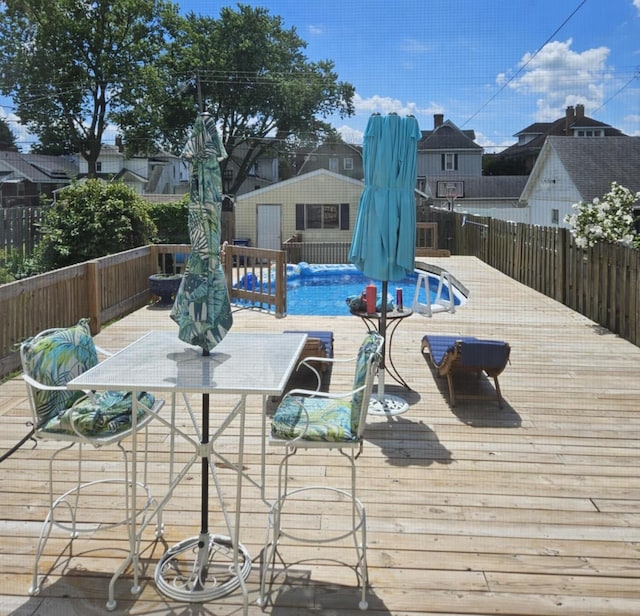 view of pool featuring a fenced in pool, an outdoor structure, and a fenced backyard