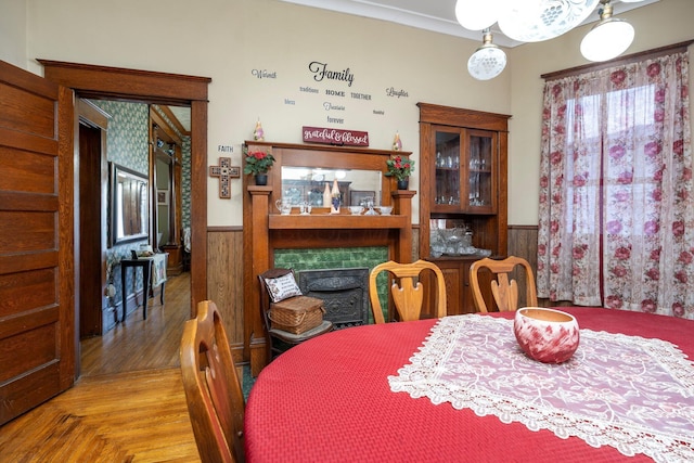 dining area with a wainscoted wall and wooden walls