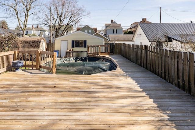 deck featuring an outdoor structure and fence