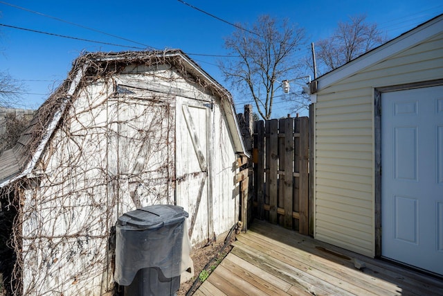 view of shed featuring fence