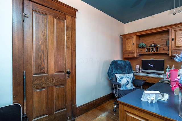 home office featuring baseboards and dark wood-style flooring