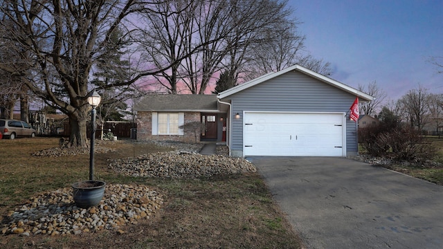 ranch-style home with driveway and a garage