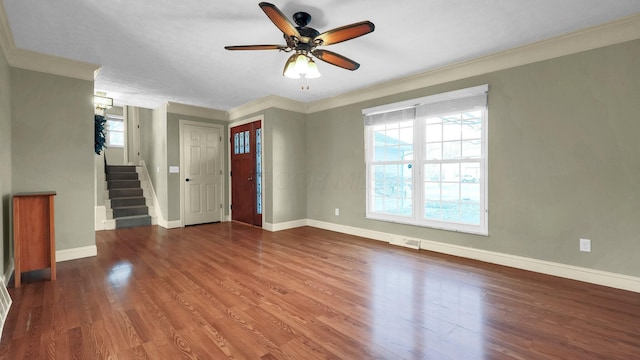 unfurnished living room with baseboards, a healthy amount of sunlight, wood finished floors, and stairs