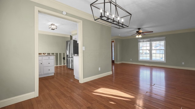 interior space featuring dark wood-type flooring, ornamental molding, baseboards, and ceiling fan