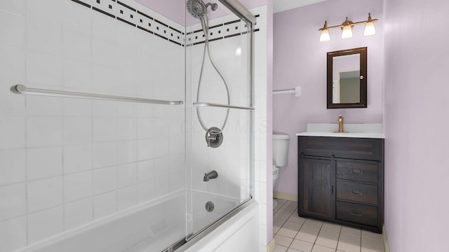 full bath with baseboards, toilet, shower / bath combination with glass door, tile patterned floors, and vanity