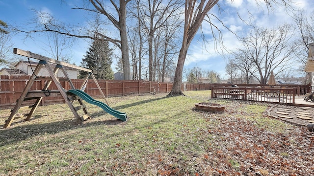 view of yard with a playground and a fenced backyard