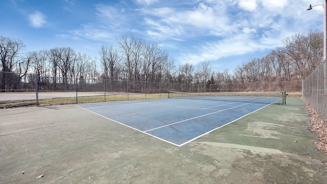 view of sport court featuring fence