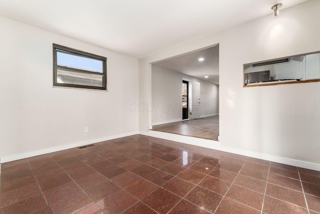 unfurnished room with visible vents, granite finish floor, recessed lighting, and baseboards