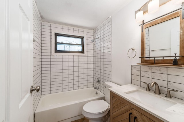 bathroom featuring tasteful backsplash, vanity, toilet, and bathing tub / shower combination