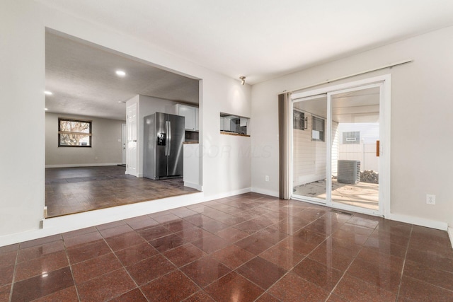 empty room featuring recessed lighting, baseboards, and granite finish floor