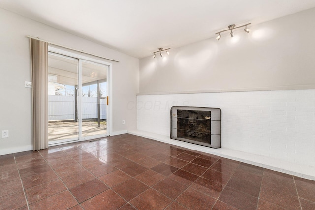 unfurnished living room featuring a fireplace and baseboards