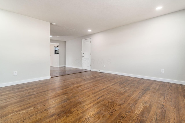 empty room with wood finished floors and baseboards