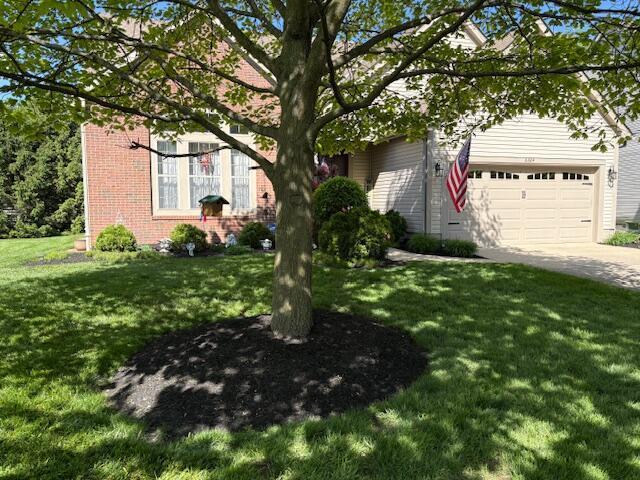 6324 Rossmore Ln, Canal Winchester, OH 43110 - obstructed view of property featuring brick siding, concrete driveway, a front lawn, and an attached garage