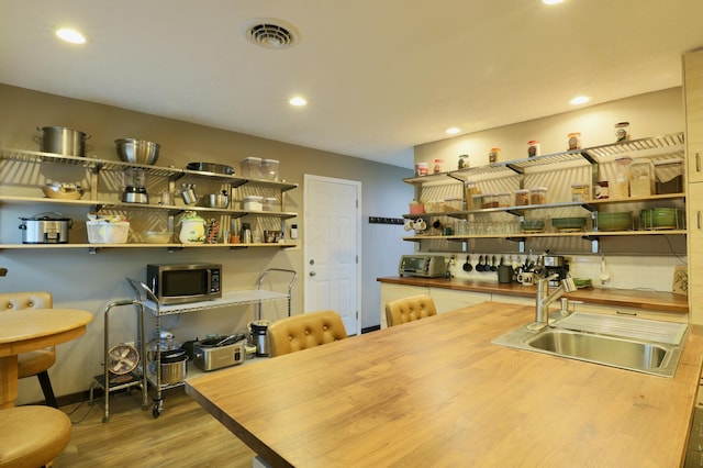 interior space featuring recessed lighting, wood finished floors, and visible vents