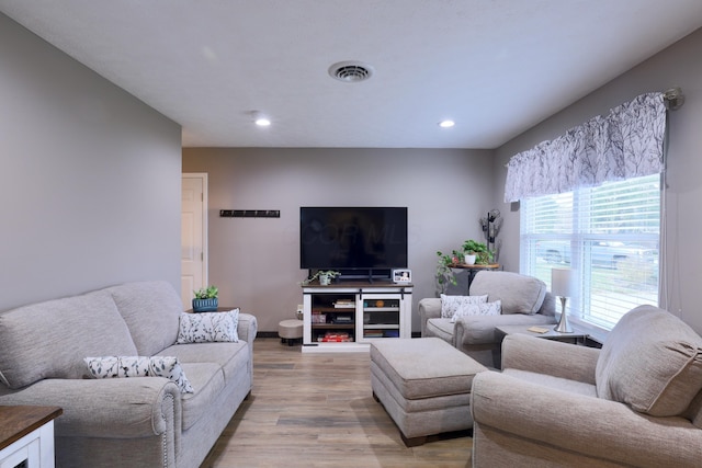 living room with recessed lighting, visible vents, and light wood-style flooring