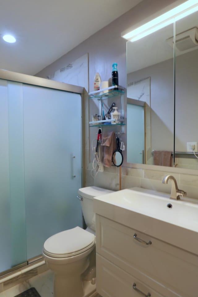 full bathroom featuring visible vents, toilet, a stall shower, and vanity