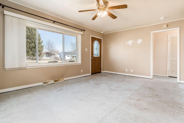 unfurnished room with baseboards, a ceiling fan, visible vents, and a textured ceiling