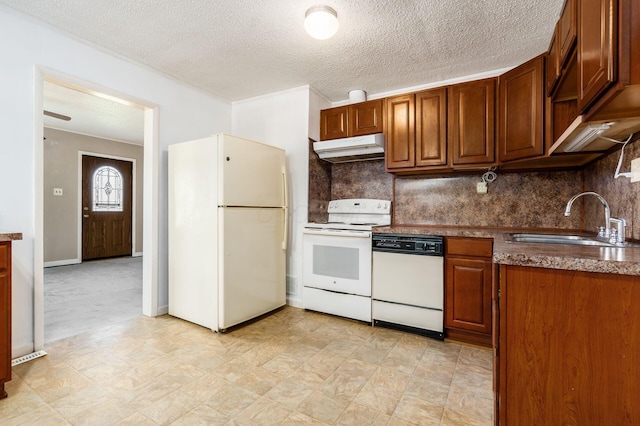 kitchen featuring white appliances, backsplash, under cabinet range hood, and a sink