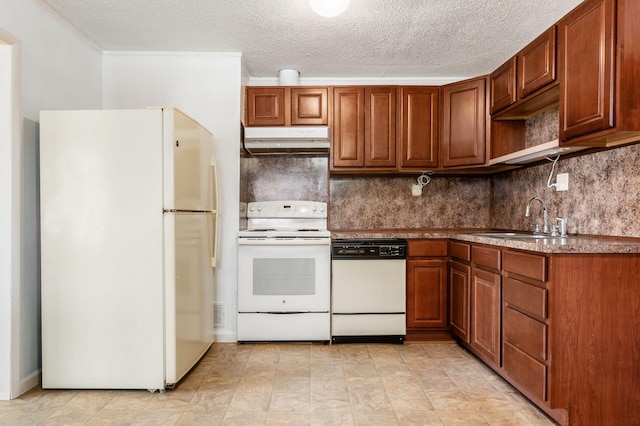 kitchen featuring under cabinet range hood, backsplash, white appliances, and a sink