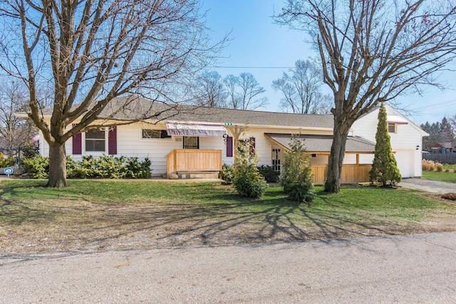 ranch-style home with a front yard and a garage