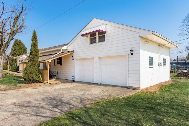 view of home's exterior with aphalt driveway and a lawn