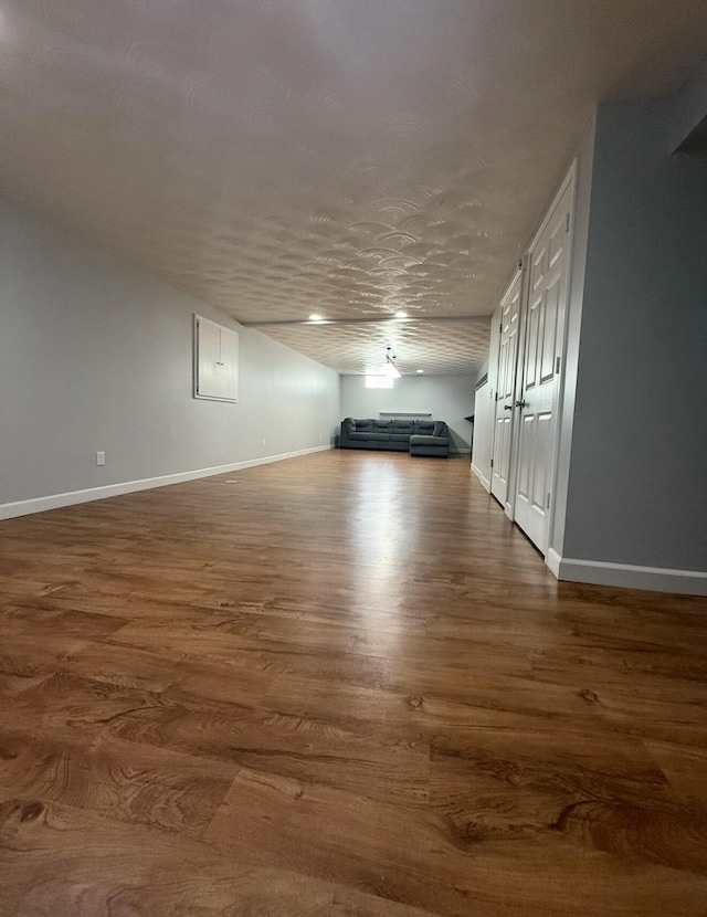 interior space with dark wood finished floors and baseboards