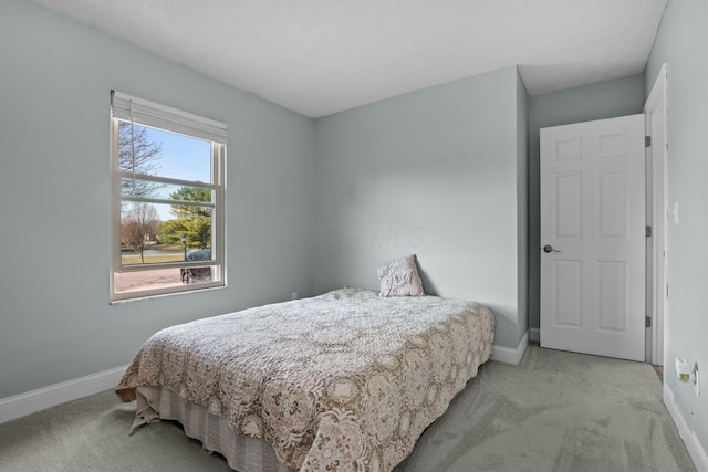 bedroom featuring baseboards and carpet