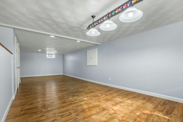 spare room featuring recessed lighting, wood finished floors, baseboards, and a textured ceiling