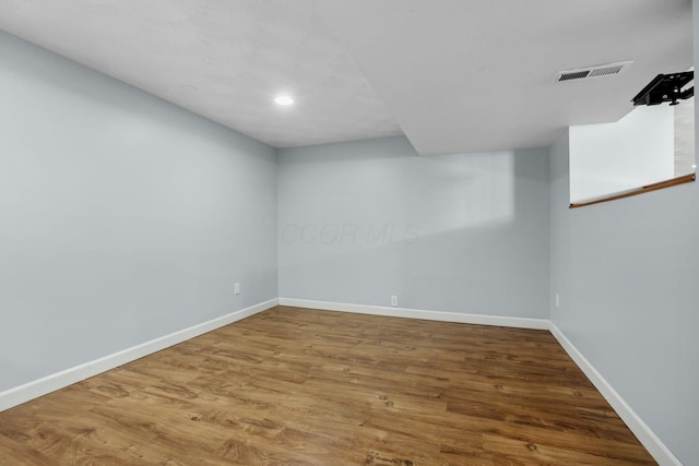 interior space featuring visible vents, baseboards, and wood finished floors