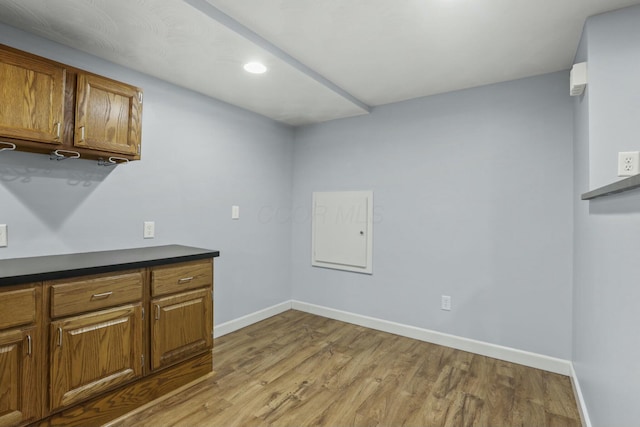 washroom with light wood-style flooring and baseboards