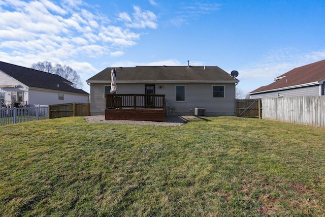 rear view of property featuring a deck, central AC unit, a lawn, and a fenced backyard