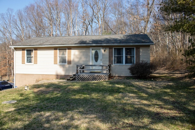 ranch-style house with a deck, a front lawn, and a shingled roof