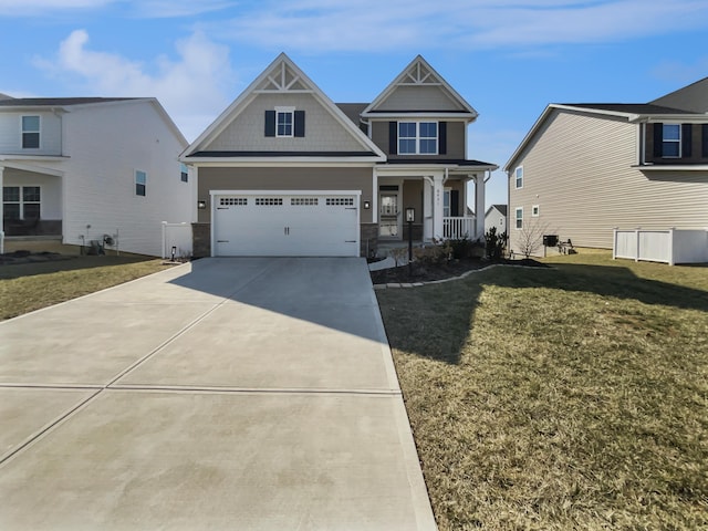 craftsman-style home featuring concrete driveway, a garage, covered porch, and a front yard