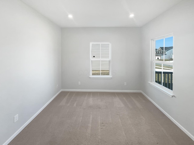 empty room featuring recessed lighting, baseboards, and carpet flooring