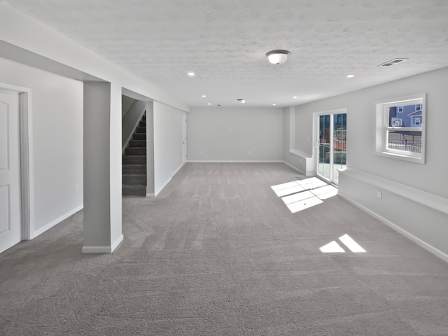 basement featuring stairway, recessed lighting, carpet, and baseboards