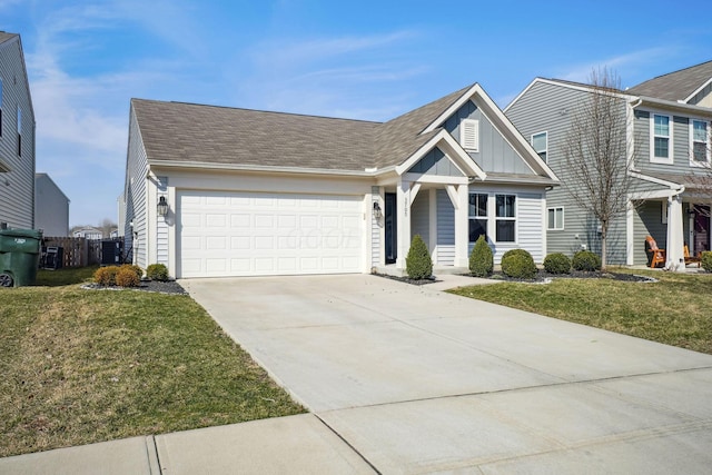 view of front facade featuring board and batten siding, a front lawn, concrete driveway, roof with shingles, and a garage