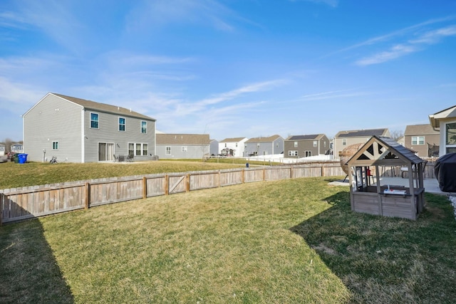 view of yard with a gazebo, a fenced backyard, and a residential view