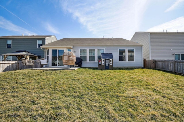 back of property featuring a patio area, a lawn, and a fenced backyard