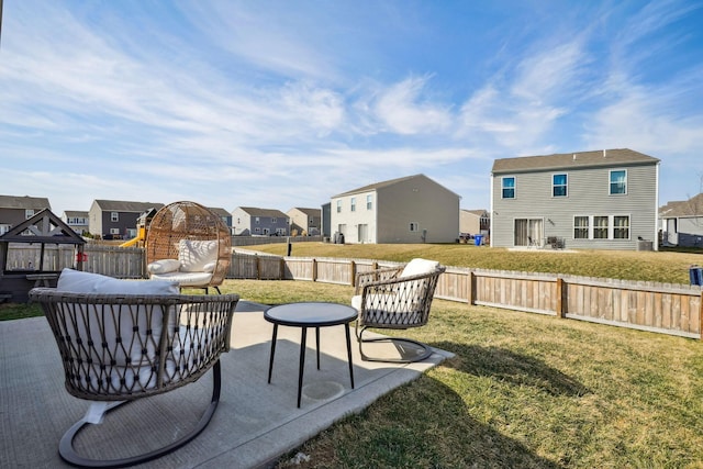 view of yard featuring a patio area, a residential view, and a fenced backyard