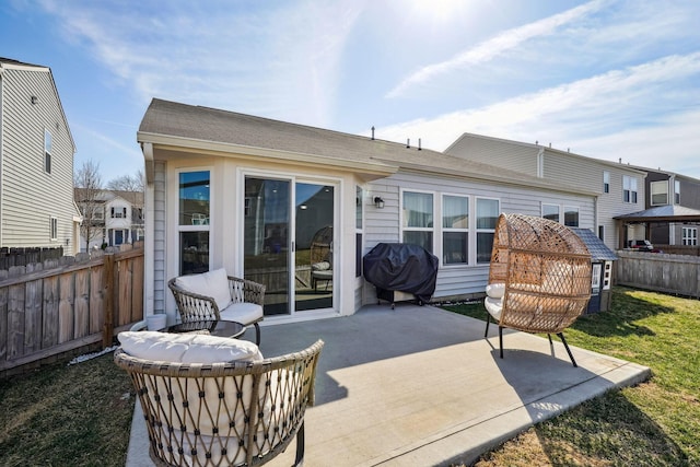 rear view of house with a patio area, a yard, and fence