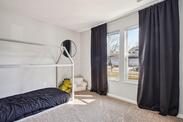 bedroom with baseboards, carpet floors, and visible vents