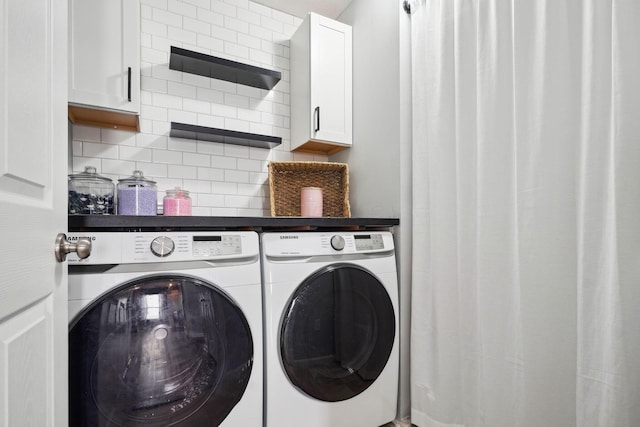 laundry room with cabinet space and washing machine and dryer