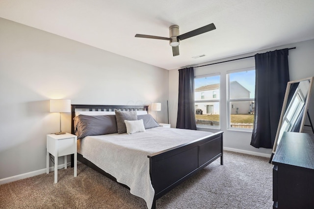 carpeted bedroom featuring visible vents, baseboards, and ceiling fan