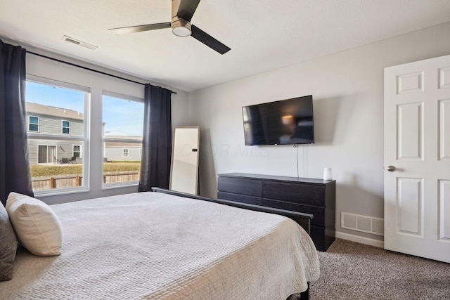 bedroom with visible vents, baseboards, carpet, and a ceiling fan