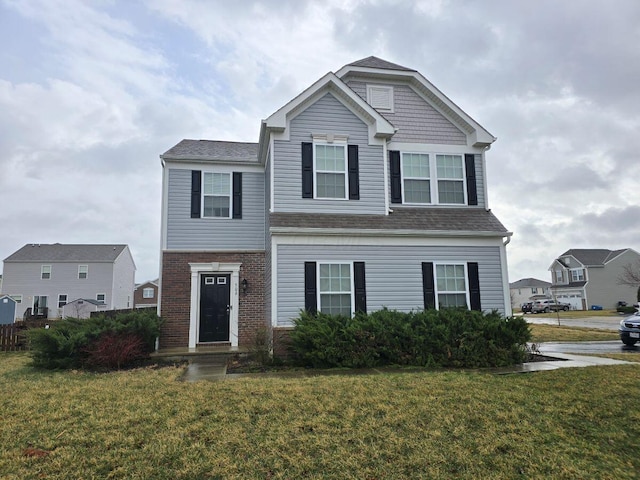 view of front of home featuring brick siding and a front yard